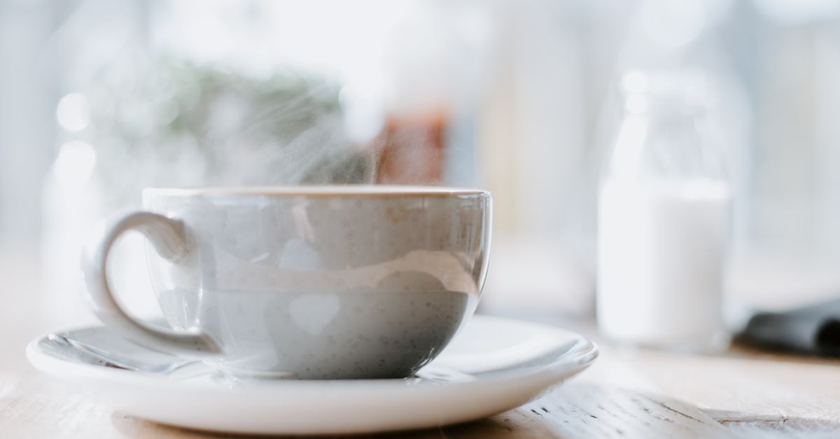 Taza de café humeante vista de cerca con vapor visible